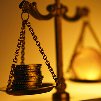 Close-up Of Globe With Coins On Weight Scale Against Wall